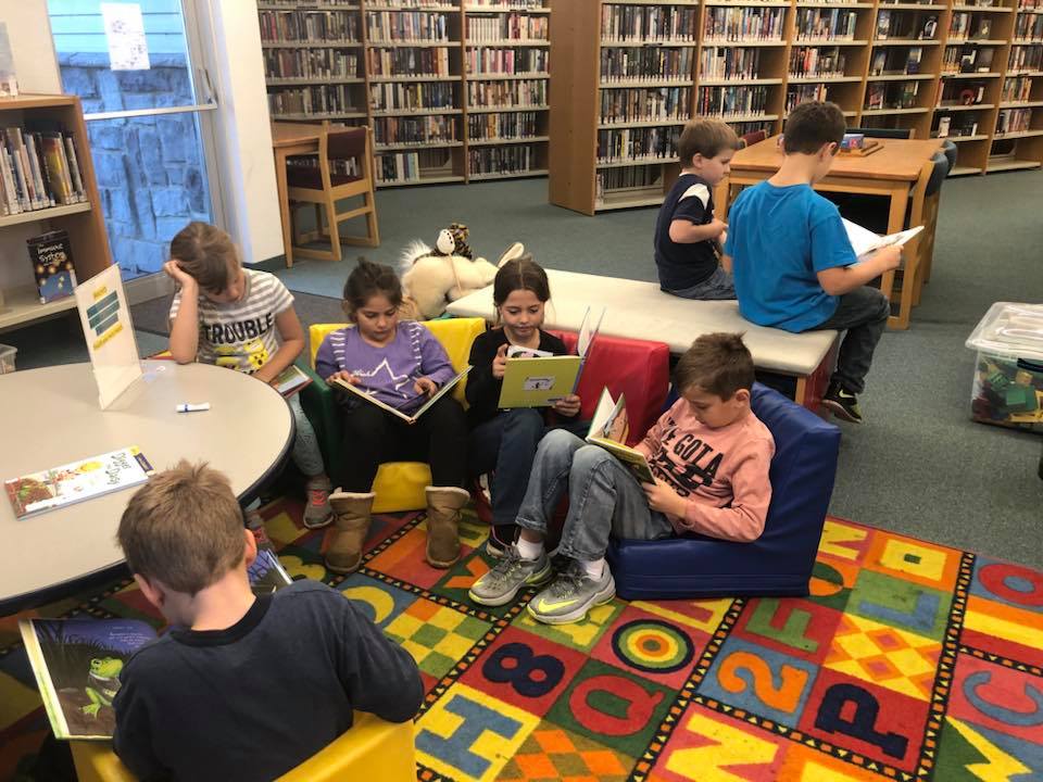 Kids reading in library